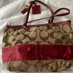 Authentic wine and brown monogram Coach shoulder bag.